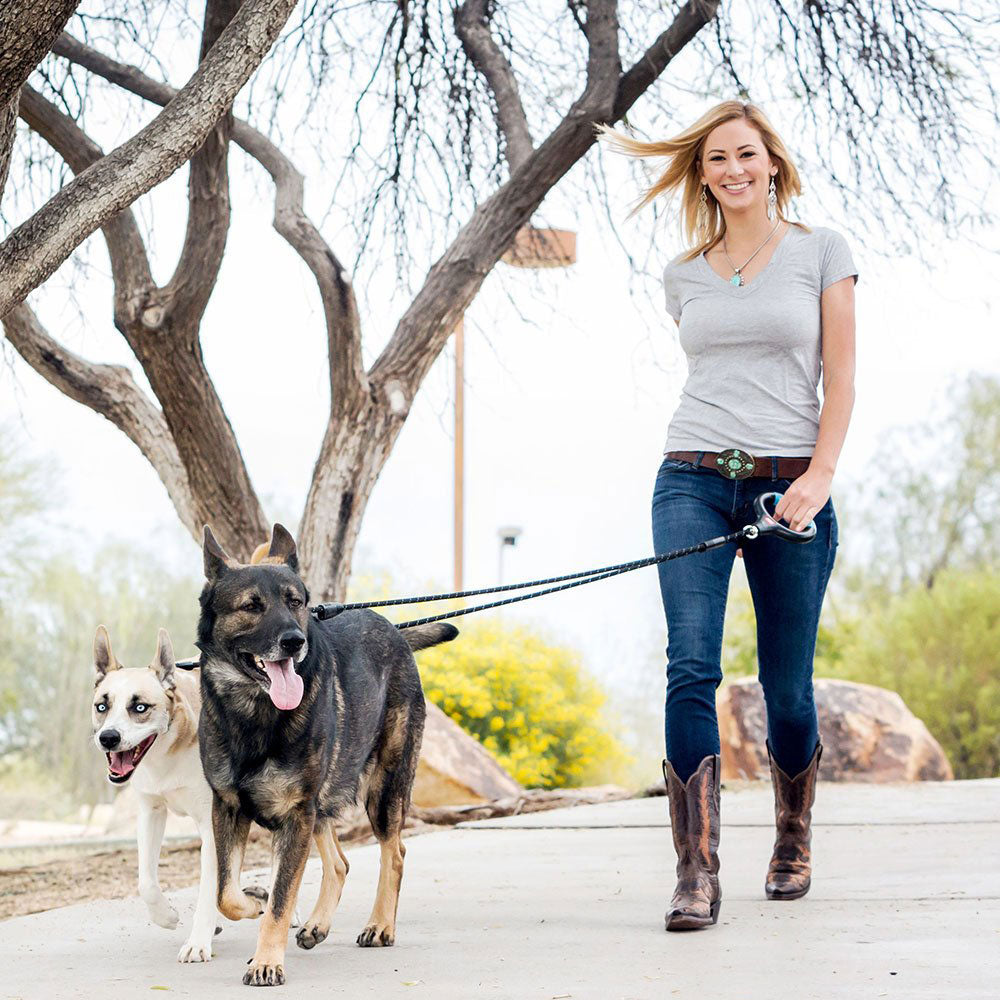 woman walking two dogs with Dual Doggie Rope Leash with gel handle